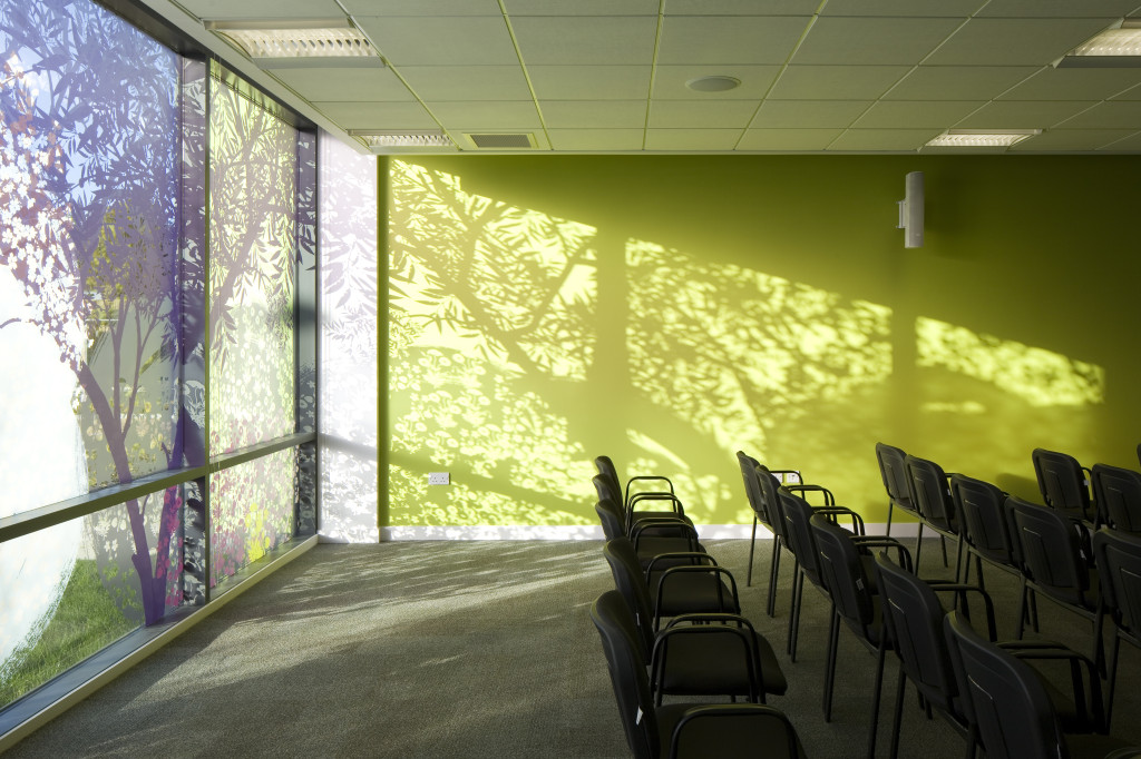 The digitally printed glazing artwork casts shadows on the adjacent walls. 