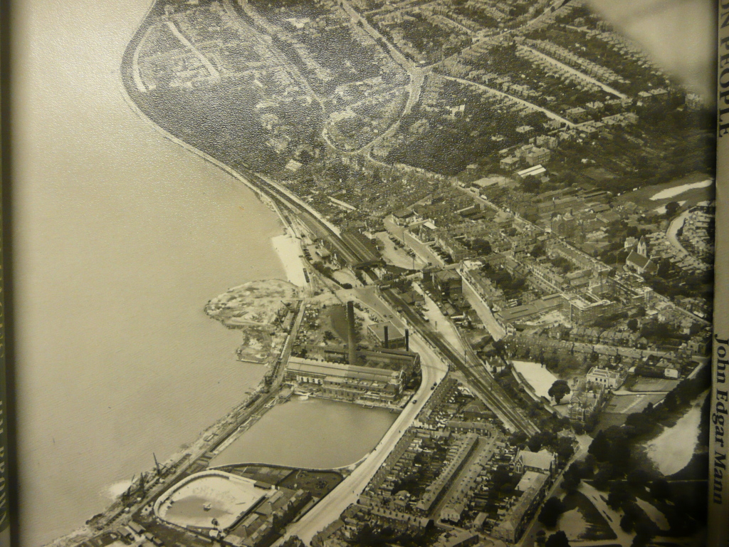 1928 saw the building of the Mayflower Theatre - known as The Empire Theatre. The Power Station of 1903 and the Lido from 1854 had begun the reclamation of land from West Bay, which was then taken to another level entirely by the docks expansion of the 1930's. Southampton Station can be see in the centre of this image. Image: SCC Local & Maritime Aerial Collection.