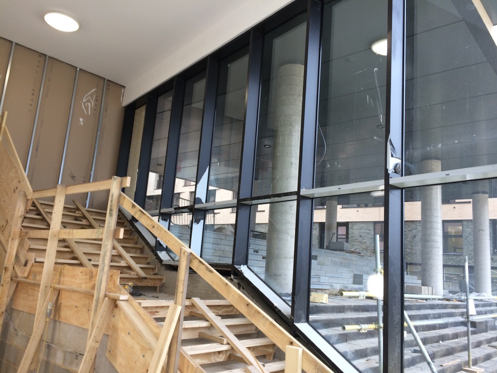 Central Chelmsford for Genesis Housing Association. Glazing manifestations are being applied to the glazed screen for M1 / M2 Block entrance lobby. Image: Christopher Tipping