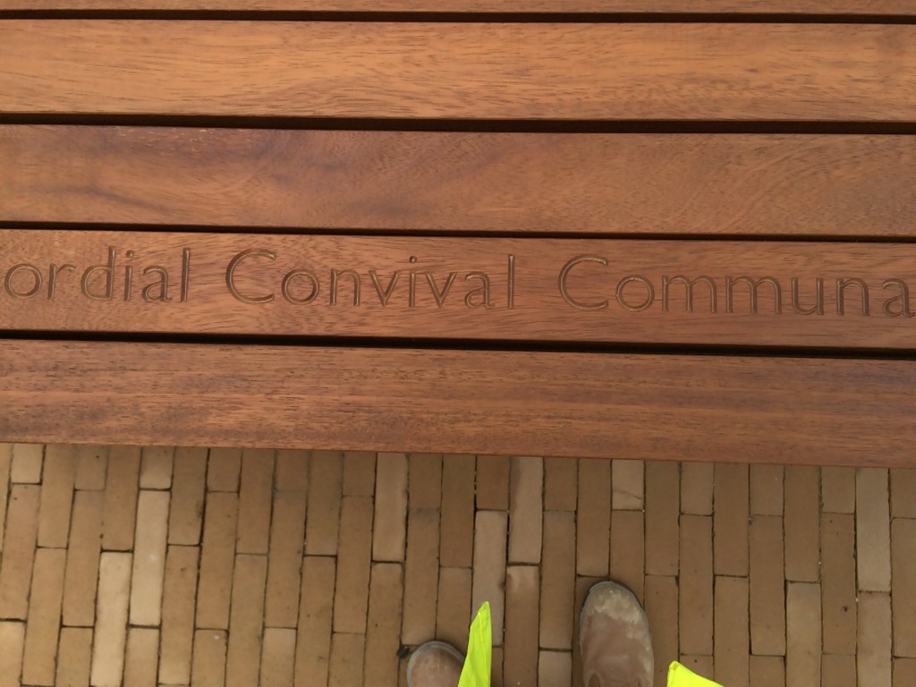 Central Chelmsford for Genesis Housing Association. Detail: cnc routed text in slatted  timber seating, part of the embedded public art interpretation, taken during installation on site. Image: Christopher Tipping